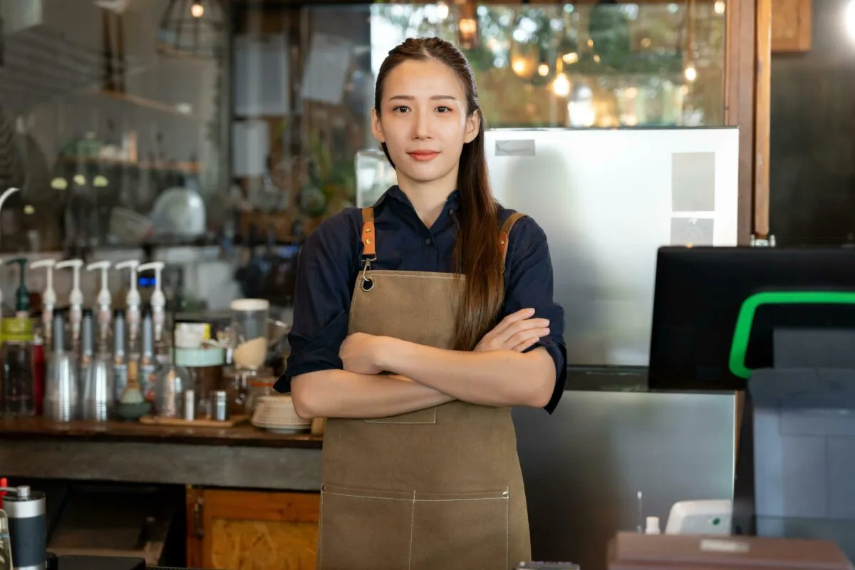 Femaile Thai staff standing at a cafe in Thailand